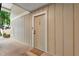 Front door of a home with beige siding, a welcome mat, and a covered porch area at 5145 Roswell Road # 3, Atlanta, GA 30342