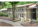 Inviting two-story condo with white stairs, offering a charming exterior and a glimpse of the surrounding greenery at 5145 Roswell Road # 3, Atlanta, GA 30342