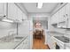 Open kitchen design with white cabinets, modern appliances, and a view of the dining area at 5145 Roswell Road # 3, Atlanta, GA 30342