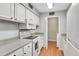 Well-lit kitchen featuring white appliances, ample counter space, and convenient access to laundry at 5145 Roswell Road # 3, Atlanta, GA 30342