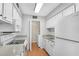 Bright kitchen with white cabinets, modern appliances, and laundry area at 5145 Roswell Road # 3, Atlanta, GA 30342