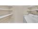 Functional laundry room with washer, dryer, and shelving for storage at 5145 Roswell Road # 3, Atlanta, GA 30342