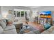 Bright living room featuring hardwood floors, a gray sectional sofa, and a large bay window with a workspace at 5145 Roswell Road # 3, Atlanta, GA 30342