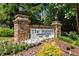 Stone entrance sign for 'The Summit' Condominium Homes surrounded by lush landscaping at 5145 Roswell Road # 3, Atlanta, GA 30342