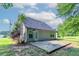 Home exterior showcasing a backyard stone patio and well-maintained lawn at 7384 Birch Hollow Pl, Douglasville, GA 30134