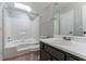 Bathroom featuring a shower-tub combo, neutral walls, a skylight, and a vanity with storage at 7384 Birch Hollow Pl, Douglasville, GA 30134