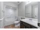 Neutral bathroom featuring a shower-tub combo, neutral walls, and a vanity with storage at 7384 Birch Hollow Pl, Douglasville, GA 30134