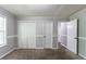 Bedroom featuring neutral walls, plush carpeting, natural light, and double closets for storage at 7384 Birch Hollow Pl, Douglasville, GA 30134