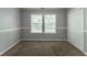 Cozy bedroom featuring plush carpeting, natural light, and a spacious closet for ample storage at 7384 Birch Hollow Pl, Douglasville, GA 30134