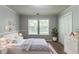 Calm bedroom with a plush rug, natural light, and neutral tones, creating a serene and inviting atmosphere at 7384 Birch Hollow Pl, Douglasville, GA 30134