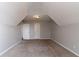 Attic bedroom featuring neutral walls, plush carpeting, and angled ceilings at 7384 Birch Hollow Pl, Douglasville, GA 30134