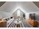 Stylish bonus room with vaulted ceilings, modern furniture, and plenty of natural light, great for entertaining at 7384 Birch Hollow Pl, Douglasville, GA 30134