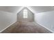 Attic bonus room with neutral walls, carpet, and a window for natural light at 7384 Birch Hollow Pl, Douglasville, GA 30134