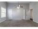 Bonus room with neutral walls and carpet features an overhead fan and multiple closets for storage at 7384 Birch Hollow Pl, Douglasville, GA 30134