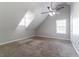 Bonus room with pitched ceilings, neutral walls, and carpet; the space is filled with natural light at 7384 Birch Hollow Pl, Douglasville, GA 30134