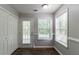 Eat-in kitchen with modern windows providing natural light and white cabinets for storage at 7384 Birch Hollow Pl, Douglasville, GA 30134