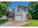 A charming home with a garage, landscaped front yard, and a covered porch, perfect for suburban living at 7384 Birch Hollow Pl, Douglasville, GA 30134