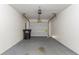 A clean and functional garage space with garage door and trash receptacle at 7384 Birch Hollow Pl, Douglasville, GA 30134