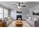 Bright living room features a cozy fireplace, plush rug, and comfortable seating, perfect for relaxation at 7384 Birch Hollow Pl, Douglasville, GA 30134