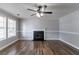 Spacious living room with gleaming hardwood floors, cozy fireplace, and bright windows, perfect for gatherings at 7384 Birch Hollow Pl, Douglasville, GA 30134