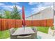 Cozy backyard patio with modern outdoor dining and string lights, ideal for relaxing or entertaining at 739 Woodstock Grove Dr, Woodstock, GA 30188