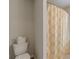 Bathroom with white toilet and a shower featuring a shower curtain with a modern pattern at 739 Woodstock Grove Dr, Woodstock, GA 30188