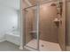 Bathroom featuring a tiled shower with a glass door, bench seat, shelving, and dual shower heads at 739 Woodstock Grove Dr, Woodstock, GA 30188