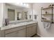 Bathroom with double granite vanity, industrial shelving, and a large mirror at 739 Woodstock Grove Dr, Woodstock, GA 30188