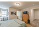 Bedroom with light-filled window, wood floors, ensuite access to a bathroom and walk-in closet at 739 Woodstock Grove Dr, Woodstock, GA 30188