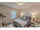 Cozy bedroom featuring light-filled window, plush carpeting and a neutral color scheme at 739 Woodstock Grove Dr, Woodstock, GA 30188