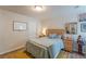 Well-lit bedroom boasts a bed, nightstands, a whiteboard for convenience, and stylish accents at 739 Woodstock Grove Dr, Woodstock, GA 30188