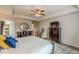 Bedroom with a ceiling fan, a light brown wooden bed frame, dresser, a desk, and tv at 739 Woodstock Grove Dr, Woodstock, GA 30188