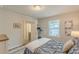 Comfortable bedroom featuring a light-filled window and ensuite bathroom at 739 Woodstock Grove Dr, Woodstock, GA 30188