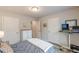 Bright bedroom featuring neutral walls, a plush bed, and a convenient workspace at 739 Woodstock Grove Dr, Woodstock, GA 30188