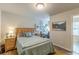 Comfortable bedroom featuring neutral walls, a plush bed, and a workspace with a white desk at 739 Woodstock Grove Dr, Woodstock, GA 30188