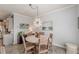 Dining area with a round wood table, seating for four, and modern chandelier at 739 Woodstock Grove Dr, Woodstock, GA 30188