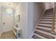Inviting entryway with stylish light fixture, staircase with runner, and charming decor at 739 Woodstock Grove Dr, Woodstock, GA 30188