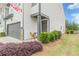 Attractive home exterior featuring an inviting front door and lush landscaping on a sunny day at 739 Woodstock Grove Dr, Woodstock, GA 30188