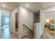 Second story hallway with three doorways leading to two bedrooms and the stairway at 739 Woodstock Grove Dr, Woodstock, GA 30188