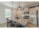 Stylish kitchen with a granite island, pendant lighting, and seating for three at 739 Woodstock Grove Dr, Woodstock, GA 30188