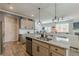 Modern kitchen with granite countertops, stainless steel appliances, and an open layout to the living area at 739 Woodstock Grove Dr, Woodstock, GA 30188