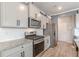 Beautiful kitchen with stainless appliances, white subway tile, and sleek granite counters at 739 Woodstock Grove Dr, Woodstock, GA 30188