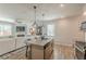 Open concept kitchen features a spacious island, stainless steel appliances, and a seamless flow to living area at 739 Woodstock Grove Dr, Woodstock, GA 30188