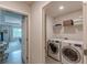 Bright laundry room featuring a modern washer and dryer, with wire shelving for optimal storage solutions at 739 Woodstock Grove Dr, Woodstock, GA 30188