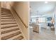 Open concept living space with staircase, modern kitchen and bright living room with fireplace at 739 Woodstock Grove Dr, Woodstock, GA 30188
