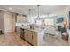 Open concept kitchen and living area boasts granite countertops and stainless steel appliances at 739 Woodstock Grove Dr, Woodstock, GA 30188