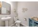 Powder room with a pedestal sink and stylish decor at 739 Woodstock Grove Dr, Woodstock, GA 30188