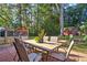 Relaxing backyard with a brick patio, wooden deck, outdoor seating and beautiful landscaping at 854 Parkway Se Dr, Smyrna, GA 30080