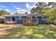 Brick patio with outdoor dining set and a wooden deck in a grassy backyard at 854 Parkway Se Dr, Smyrna, GA 30080