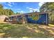 Lush backyard featuring a wooden deck and brick patio, perfect for outdoor entertaining at 854 Parkway Se Dr, Smyrna, GA 30080